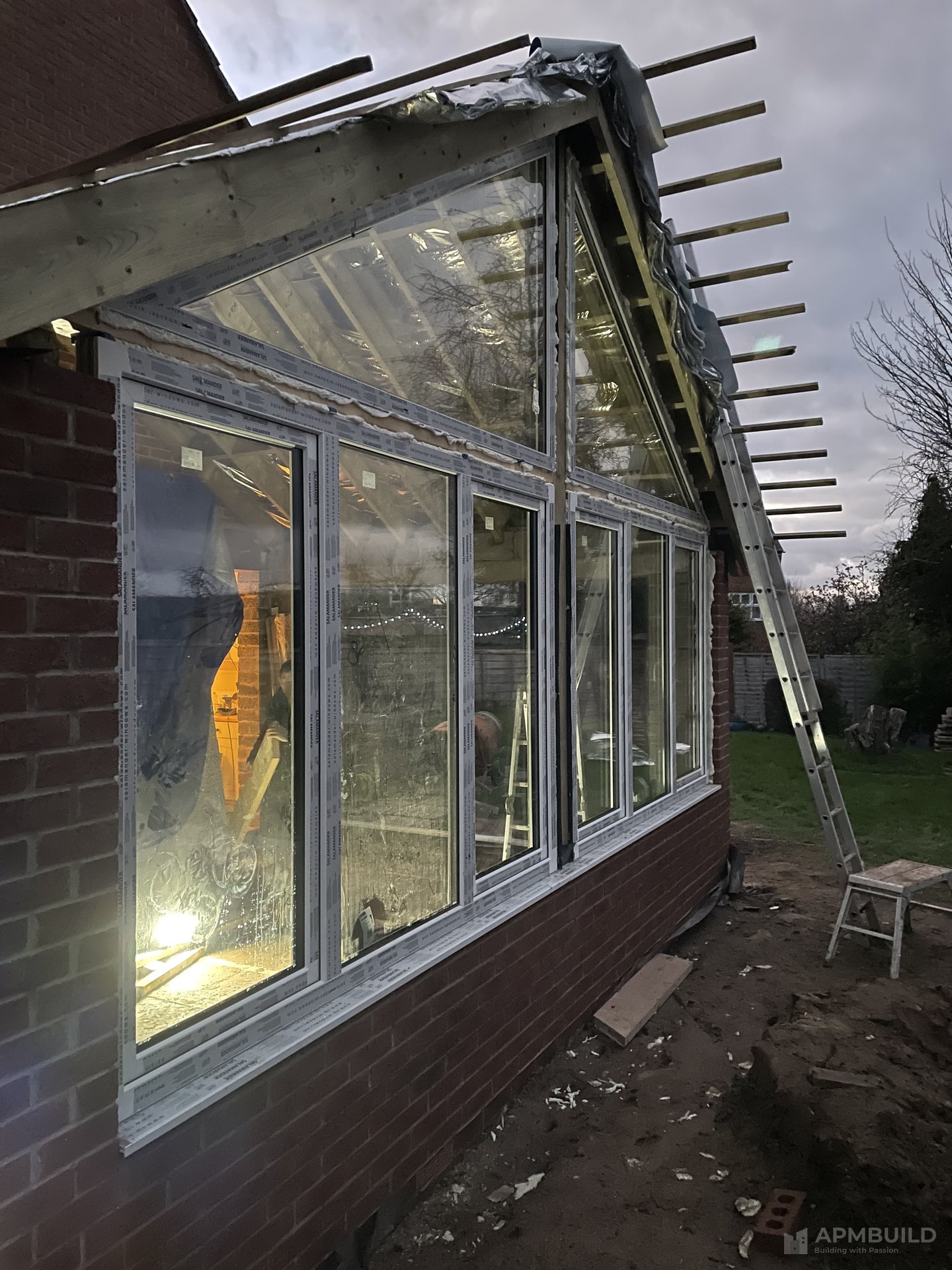 Completed orangery with brick-tile elevation and glass ridge roof in Dorminghton by APMBuild, Herefordshire