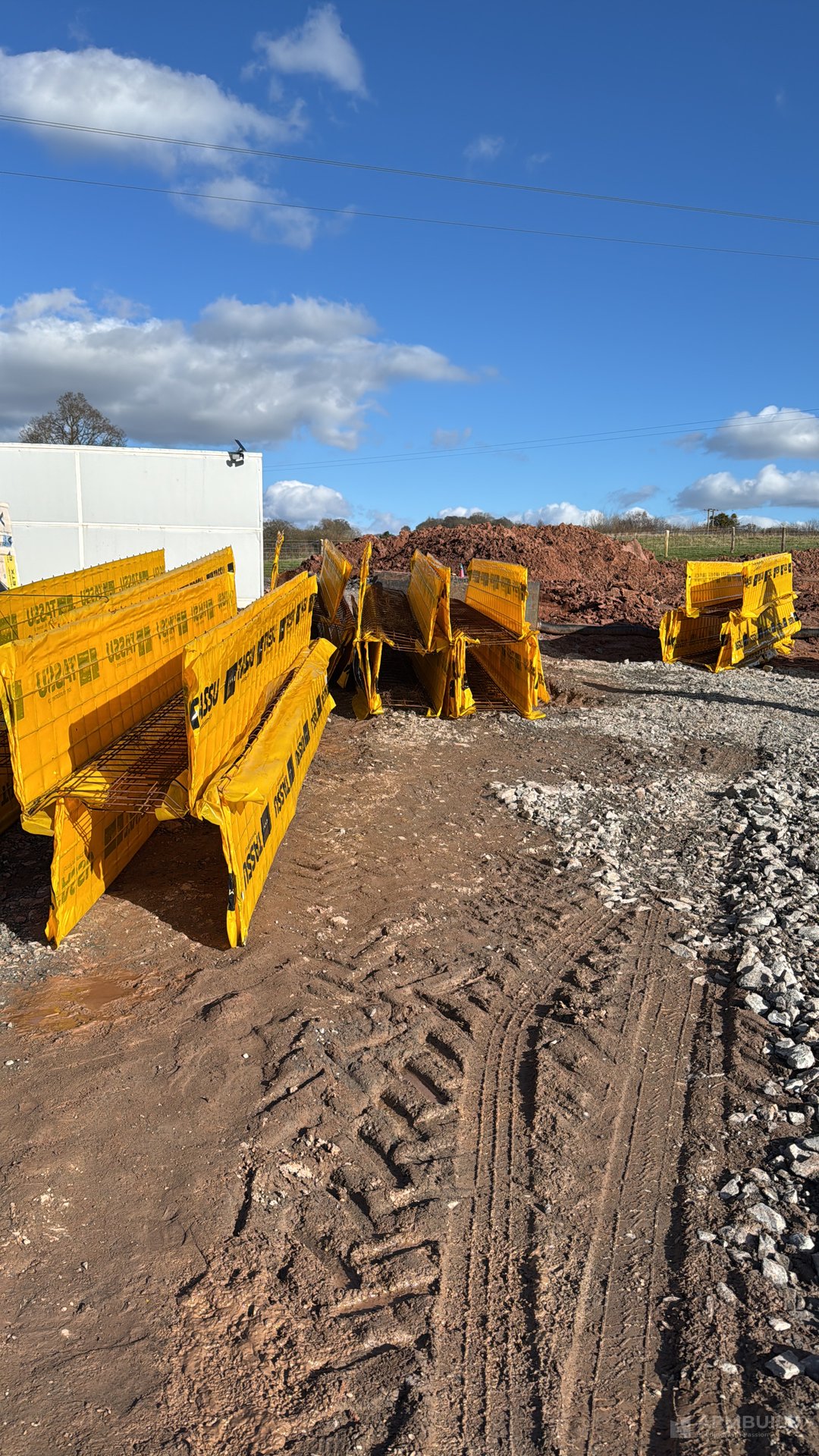 Lammi Tassu yellow ICF foundation blocks on pallets ready for a Passivhaus-grade foundation near Ledbury by APMBuild, Herefordshire