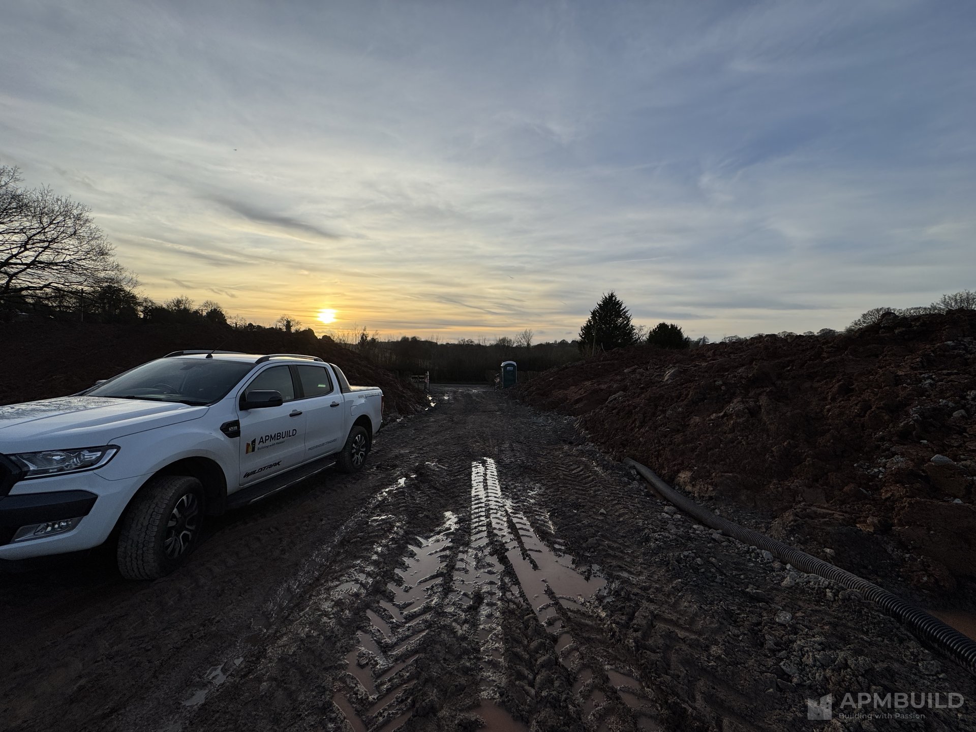 APMBuild branded pickup truck on ICF foundation site at sunset near Ledbury, Herefordshire