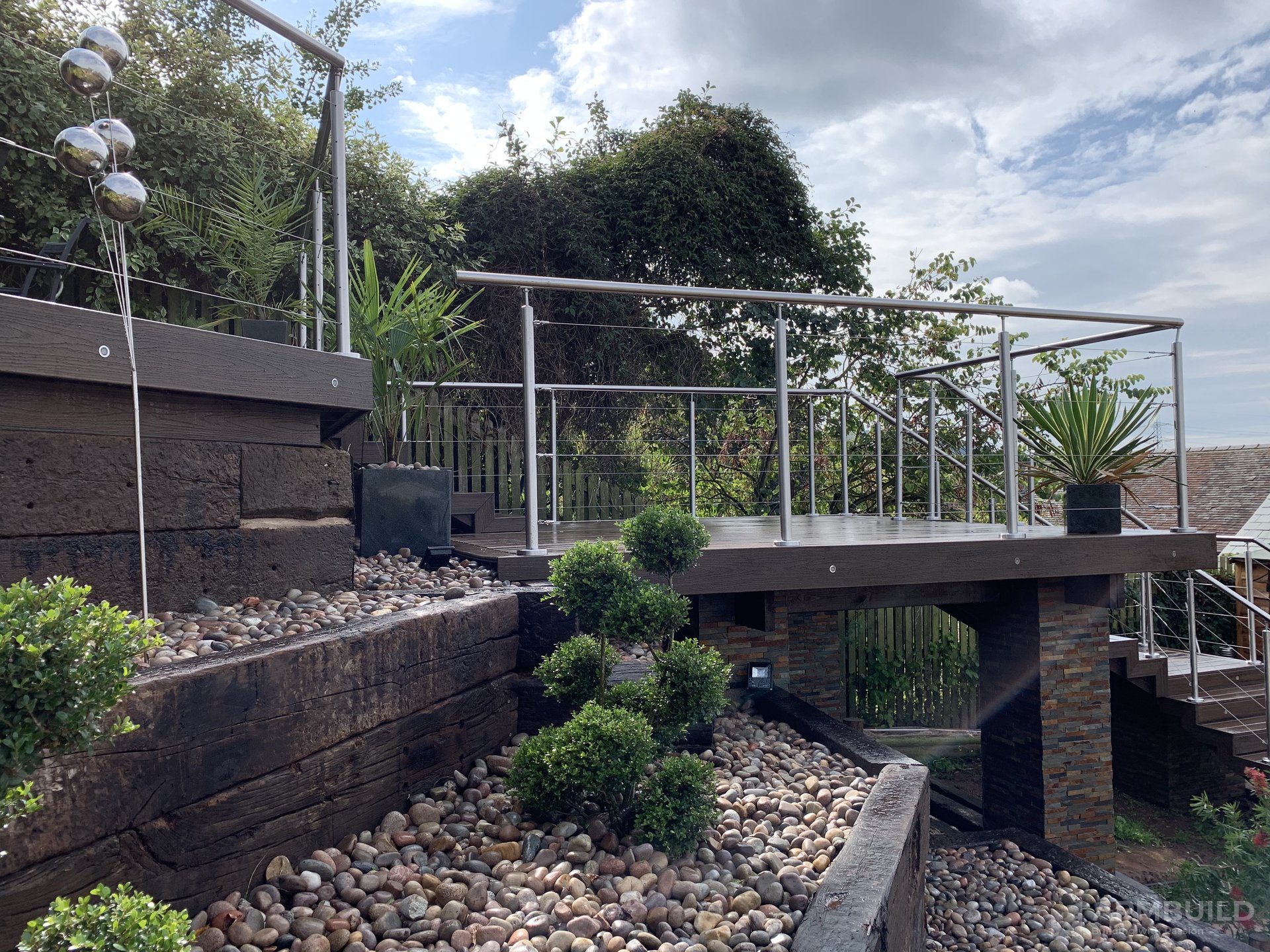 Elevated composite-deck viewing terrace with stainless cable balustrade in Lea Ross-on-Wye by APMBuild, Herefordshire