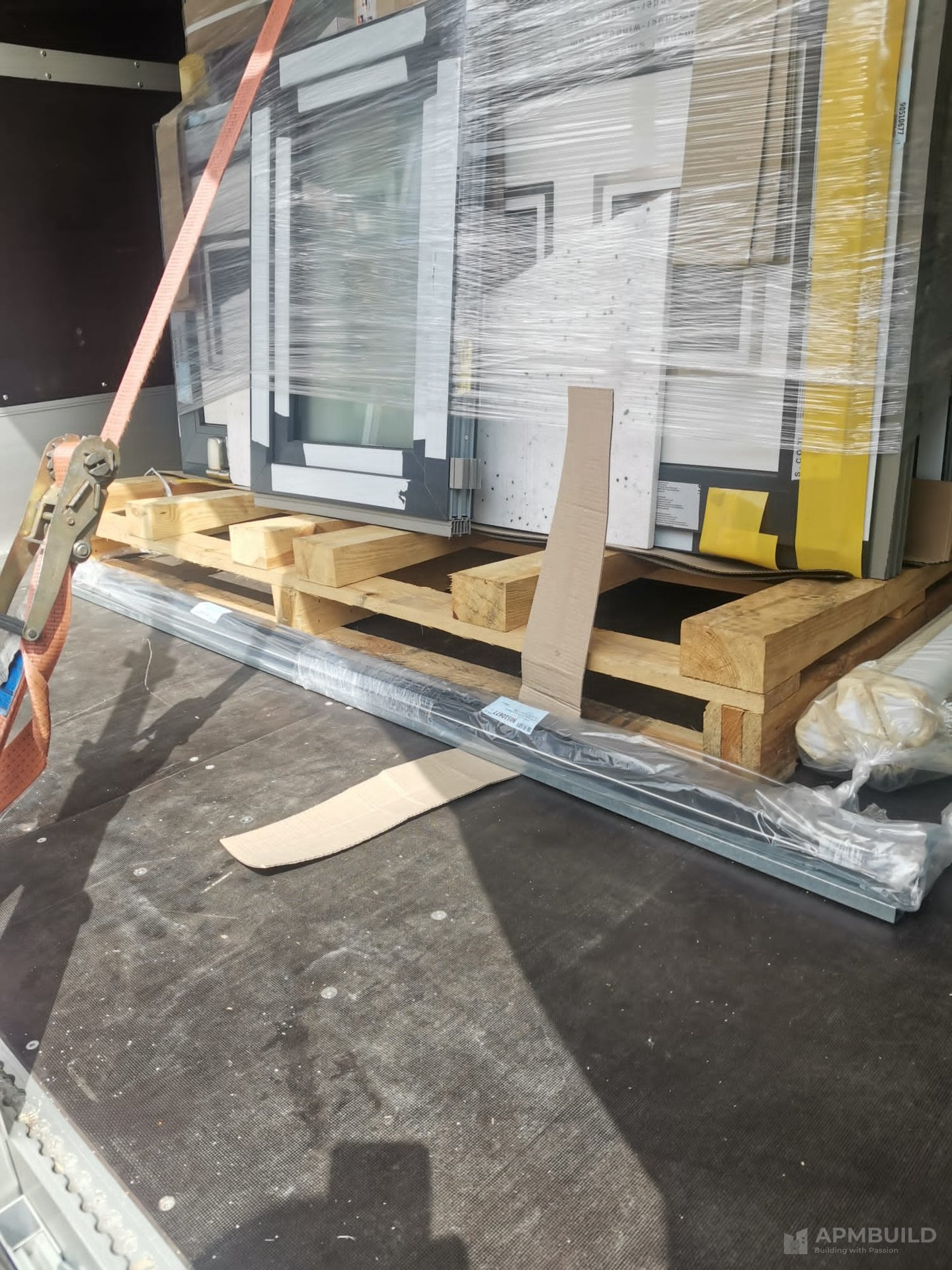 EU-manufactured triple-glazed window unit palletised for delivery by APMBuild to Herefordshire